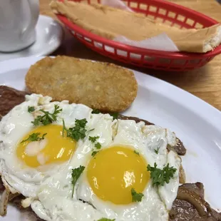 Our Palmas Steak n' Eggs. Palomilla Steak topped with Grilled Onions. Two Eggs Any Style. Hash Brown or French Fries. Toast and Coffee