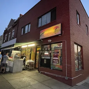 people standing outside of a restaurant