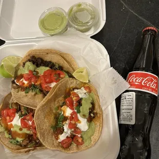 a bottle of coke and two tacos