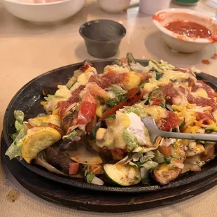 Combo fajitas after I mixed queso, guac, salsa, and lettuce. This plate was really good. Skipped the beans, rice and tortillas.