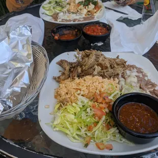 Front: Carnitas plate Back: Fish taco plate  Prices: fair