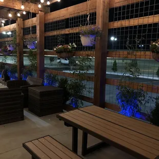 a patio with tables and benches