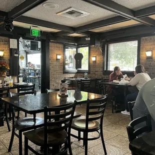 people sitting at tables in a restaurant