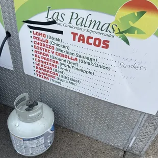 a gas can and a sign for tacos
