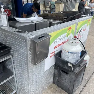 a man preparing food on a street corner