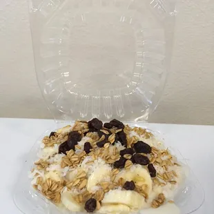 a plastic container filled with fruit and granola