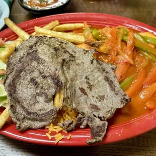 Mar y Tierra - large shrimps and beef meat served with rice, fries and salad.