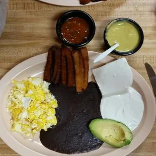 Scrambled eggs, beans, cheese, cream, fried plantains.