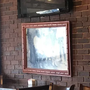 a brick wall with a painting on it