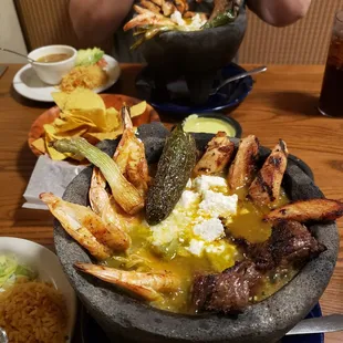 a man taking a picture of a bowl of food