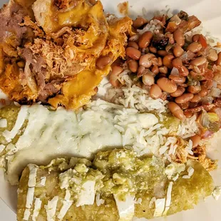 Enchiladas Verdes with a side of nachos, rice and charro beans
