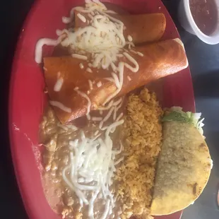 Combination #1. Beef enchilada, chicken enchilada, taco, rice and beans.