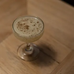 a drink in a glass on a table