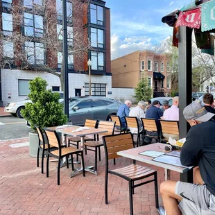 a man sitting at a table outside