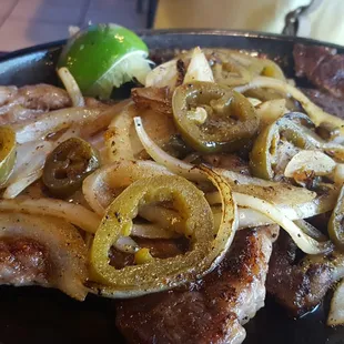 Carne Asada. Steak with grilled onions and peppers.