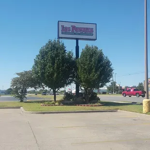 a parking lot with a large sign