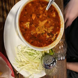 a bowl of soup and tortillas