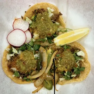 three tacos with toppings