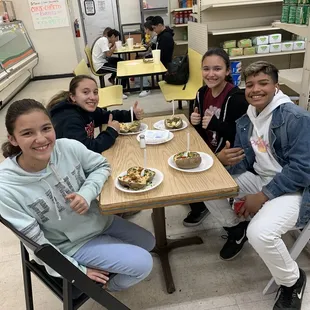 a group of girls sitting at a table