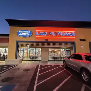 a car parked in front of a restaurant