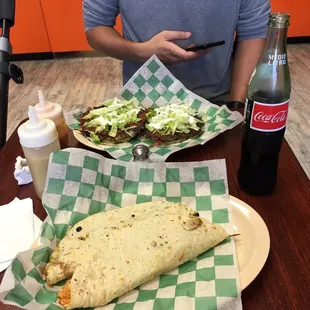 a man sitting at a table with a plate of food