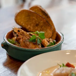 a bowl of shrimp and bread