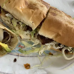 a half eaten sandwich on a plate