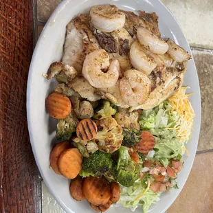 Grilled Tilapia and shrimp with grilled veggies and guacamole salad.