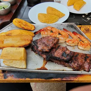 Combo - skirt steak and shrimp. Empanada apps in the back