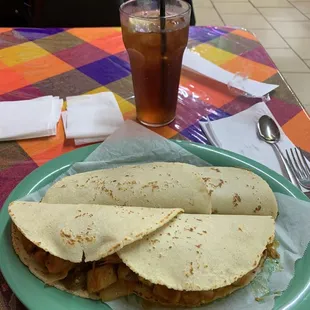 Two large tacos on homemade corn and unsweet tea