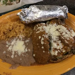Chicken and cheese Chile Rellenos with rice, beans, and warm tortillas