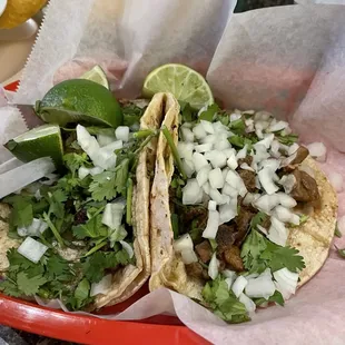 Cabeza and asada tacos with cilantro, onion, and lime