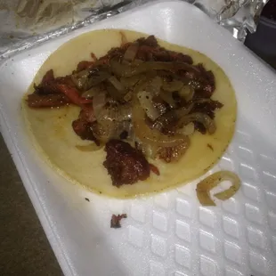 Al Pastor taco with grilled onions