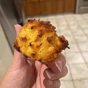a hand holding a fried food item