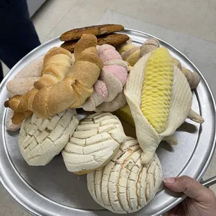 a person holding a tray of food