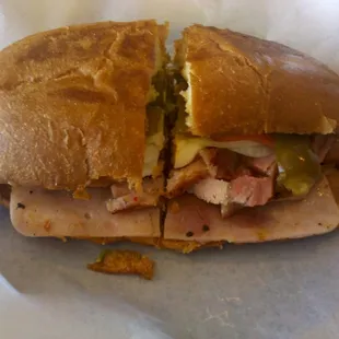 The Tejana - pork, ham, oaxaca cheese, refried beans, tomatoes, onions, avocado, and jalapenos