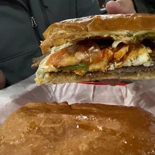 a person holding a sandwich