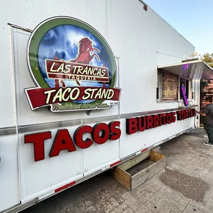 a taco stand in a parking lot