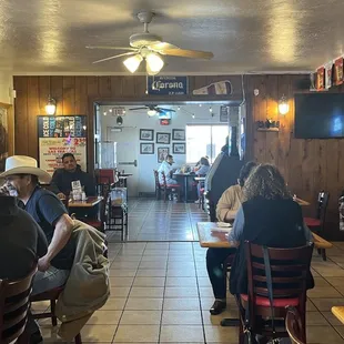 people sitting at tables in a restaurant