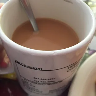 a cup of coffee with a spoon in it