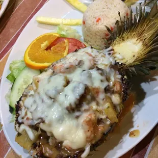 Piña Azteca Yes, that is a half roasted pineapple and I just ate that! Shrimp &amp; Steak with melted chipotle cheese.