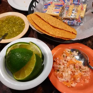 Complimentary ceviche, salsa, tostada chips and lime