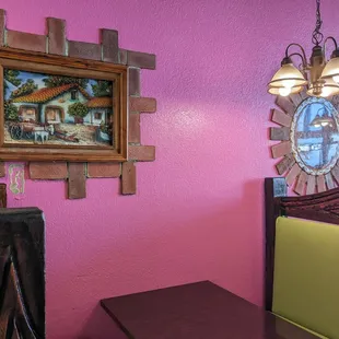 a dining room with a pink wall