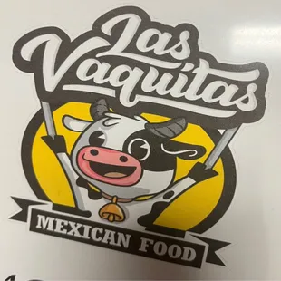 a cow holding a sign