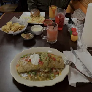 Burger and burrito with green sauce