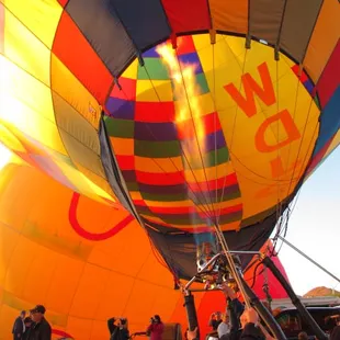 After a fan has somewhat inflated the balloon, the pilot blast hot air into the funnel