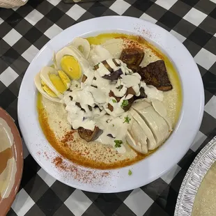 hummus plate with sabich, egg, tahini, and eggplant