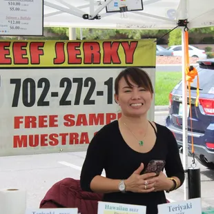 a woman standing under a tent
