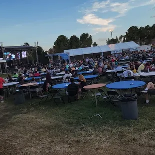 a large crowd of people sitting at tables