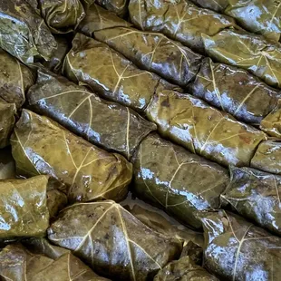 a tray of stuffed grape leaves